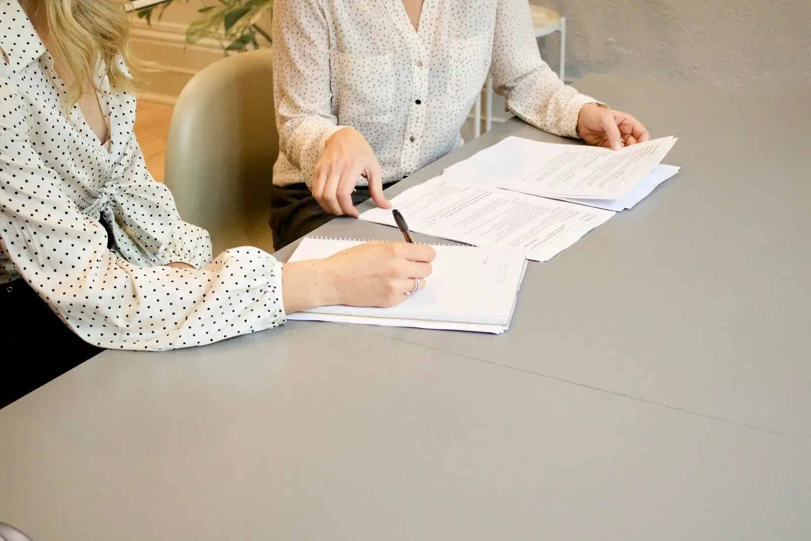 Two people reviewing and signing documents